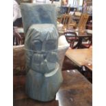 A carved and stained pine totem figure, signed with a device and dated 1971