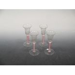 A set of four dutch colour twist wine glasses, late 18th/early 19th century, bell bowls engraved