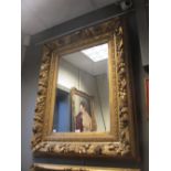 A gesso gilded portrait frame with mirror, sight size 69 x 49cm, overall size 107 x 85cm
