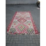 A geometrically figured Kelim small carpet, 9ft 4in x 5ft 6in (worn)