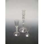 A wine glass with ribbed bowl and air twist stem, 19cm. A Jacobite type glass candlestick, the