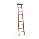 A 19th century stained pine library ladder, with a rexine cloth padded top rail, 186cm h