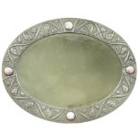 An Arts & Crafts pewter oval bevelled wall mirror, the frame with hand-beaten and repousse