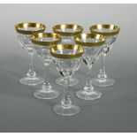 A set of eight Moser Lady Hamilton pattern liqueur glasses, the facetted bowls with gilt rims,