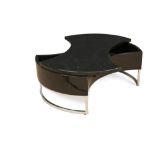 A modernist black lacquer coffee table, the waisted pivoting top turning to create a circular top