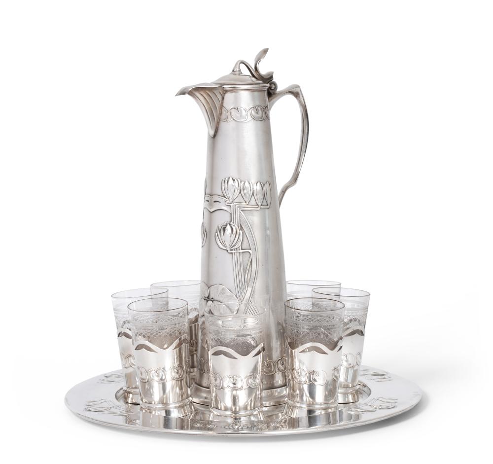 An Art Nouveau continental electroplated wine service, with stylised lotus flower and lily pad