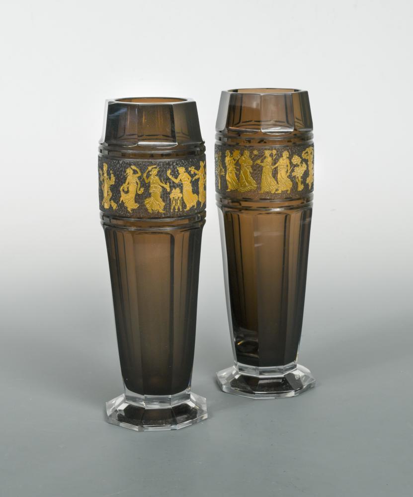 A pair of Moser glass vases, the facetted amethyst glass vases each etched and gilded with a