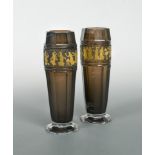 A pair of Moser glass vases, the facetted amethyst glass vases each etched and gilded with a