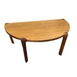 A Danish teak demi-lune coffee table by Soro Stolefabrik, raised on four rounded rectangular legs,