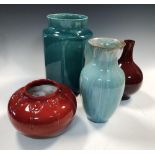 Four Pilkington's Lancastrian vases, the first of bottle form with red lustre glaze, another of