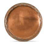 Hugh Wallis of Altrincham (British, 1871-1943), a large Arts & Crafts copper tray, of circular