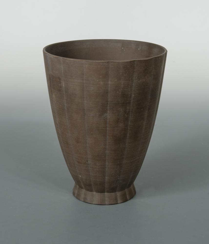 Keith Murray for Wedgwood, a brown basalt vase, of tapering cylindrical form, printed and