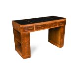 An Art Deco leather inset walnut writing table, the three part leathered top over three frieze