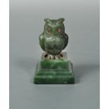 A jade and gem-set model of an owl in the manner of Fabergé, the carved jade owl with ruby eyes a