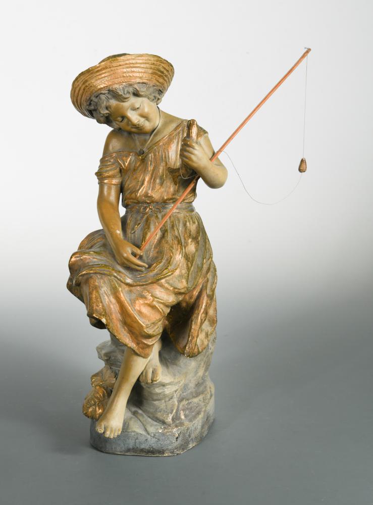 A Goldscheider terracotta model of a young girl fishing, she sits perched upon a rock holding her