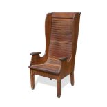 An early 20th century oak wing back arm chair, the slatted back and seat on four square legs, signed