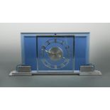 Garrard Le Coultre, an Art Deco chrome and blue glass mantel clock, the stepped bevelled blue