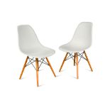 Charles and Ray Eames, a pair of modern Vitra shell chairs, the white moulded plastic seat on