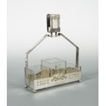 A Jugendstil electroplated cruet frame, with central vesta above three cuboid glass liners, raised