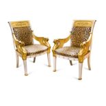 A pair of mid-20th Century Empire style white-painted and parcel gilt fauteuils, each with a