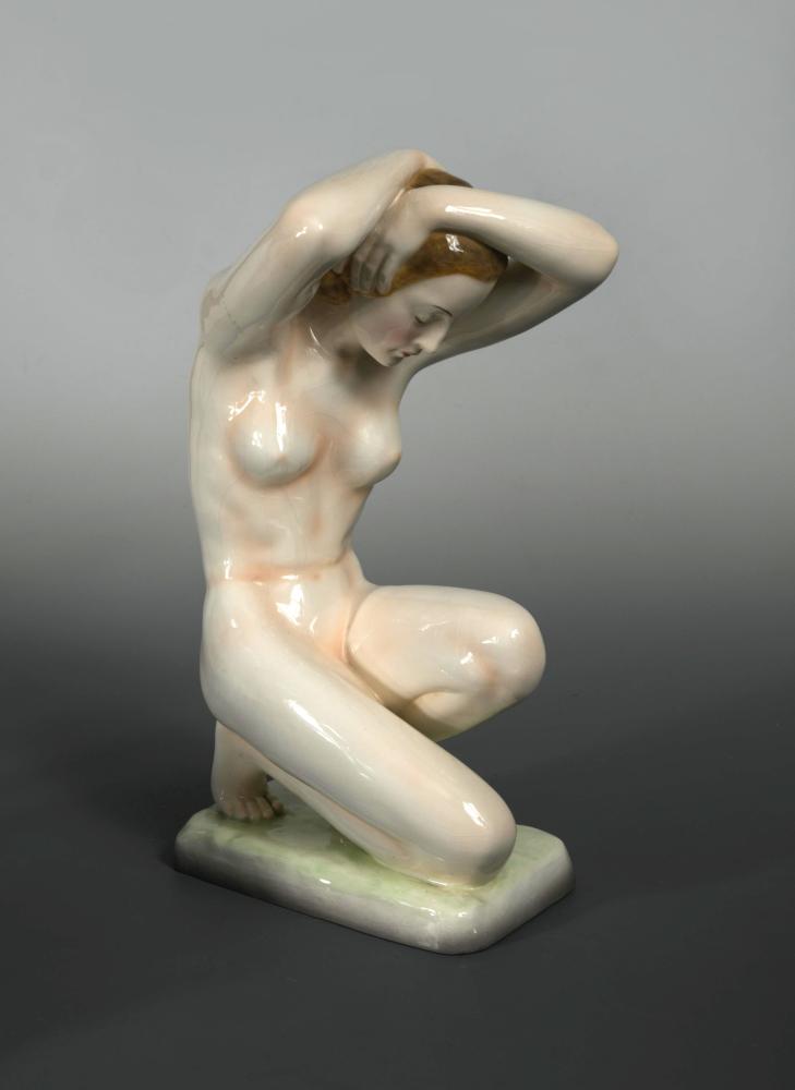 A large Goldscheider nude study, modelled in crouching pose on a rectangular base with black printed