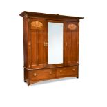 Attributed to E. A. Taylor for Wylie and Lochhead, a Glasgow School walnut triple wardrobe, the