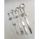 A harlequin collection of 8 Art Nouveau style Danish metalwares silver spoons, with silver plated