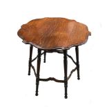 In the manner of Morris & Co., an Arts & Crafts oak occasional table, the shaped top on six turned