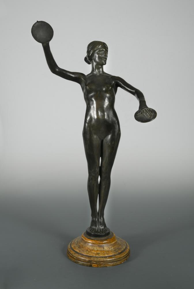 An early 20th century bronze model of a cymbal playing female nude, modelled standing on tip toes,