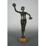 An early 20th century bronze model of a cymbal playing female nude, modelled standing on tip toes,
