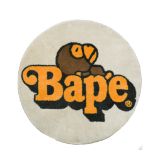 A Bathing Ape (BAPE) a small circular rug, with a central brand motif 70cm (27in)