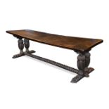 A 17th century style oak refectory table, on carved baluster column supports and chip carved feet 73