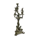 A late 19th century patinated bronze six-branch candelabra, the base with three putti 76cm (30in)
