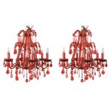 A pair of six branch red glass chandeliers, each encrusted with glass beads and pendant drops (2) 52