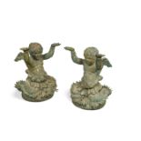 A pair of Continental patinated bronze bust-length figures of half putti, with hands aloft 63 x 48cm