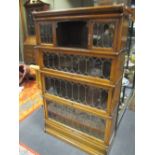 An oak leaded glazed four section stacking bookcase, 147cm high, 86cm wide