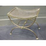 A brass X framed stool