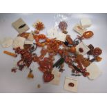 A collection of amber coloured jewellery and loose samples