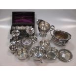 A collection of silver including a cream jug, a tea strainer a pin tray, a mustard, a bonbon dish, a