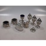 Four silver pierced pepper casters, together with a pair of open salts and a pair of mustards all