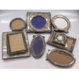 A collection of 9 silver easal backed photograph frames