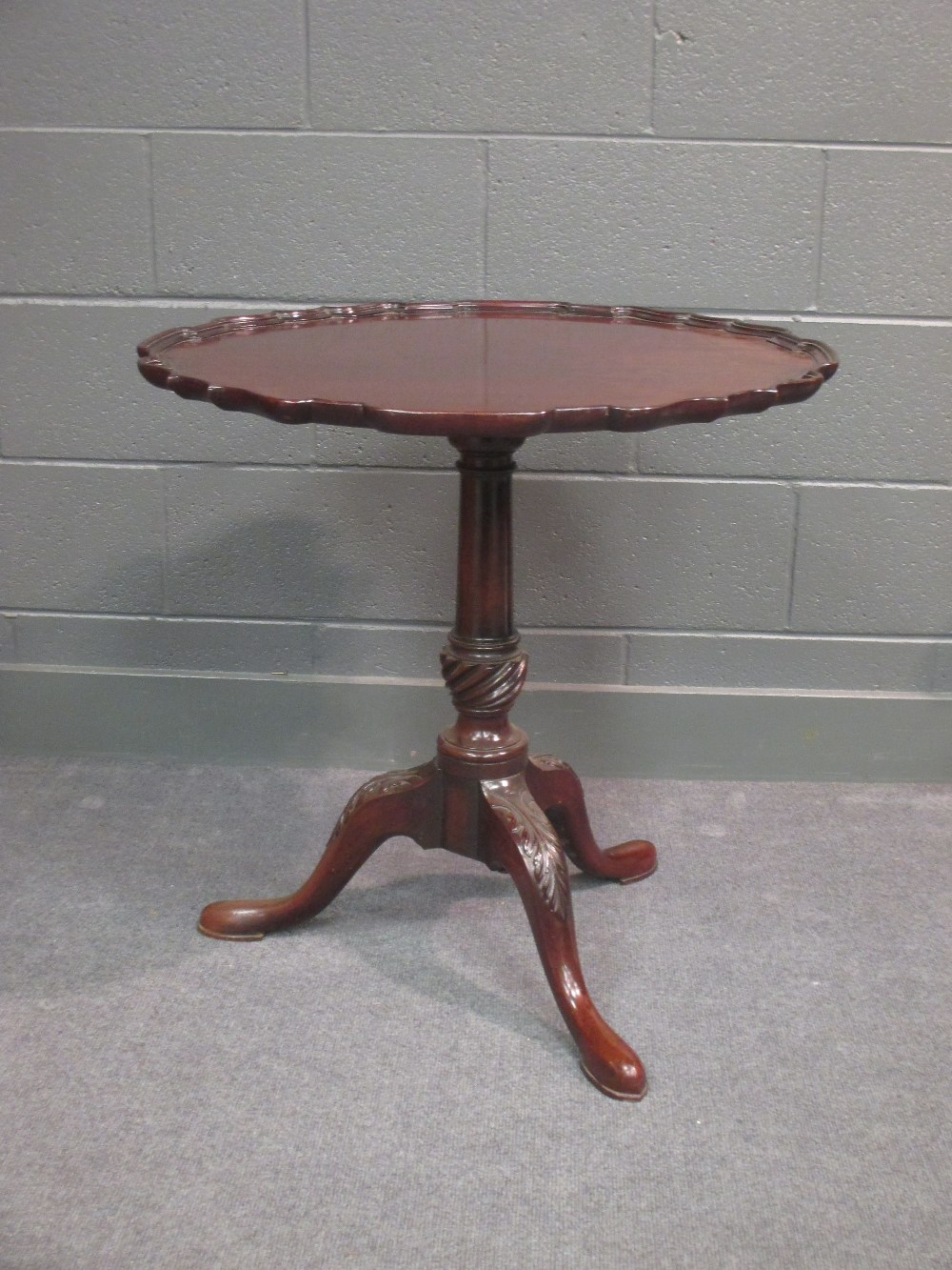 An 18th century mahogany pie crust tilt top tripod table