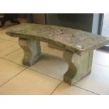 A curved composite stone garden bench approx 110cm wide