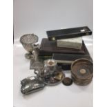 A silver dwarf candlestick, cased teaspoons, pair plated bottle coasters, and various plated items
