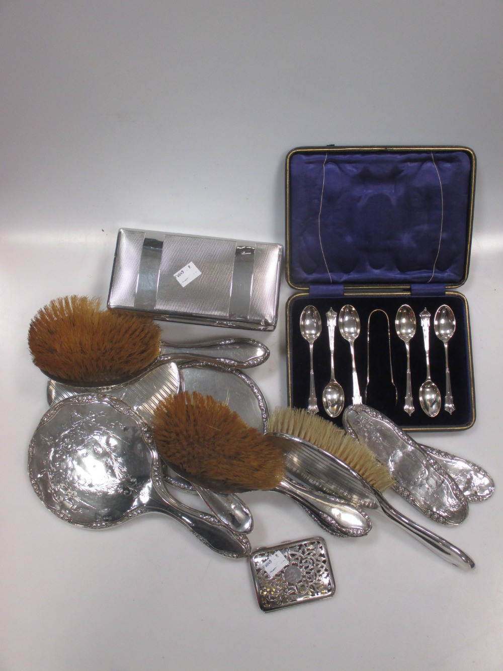 A collection of silver backed dressing table mirrors and brushes, together with a cased set of