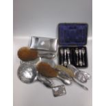 A collection of silver backed dressing table mirrors and brushes, together with a cased set of