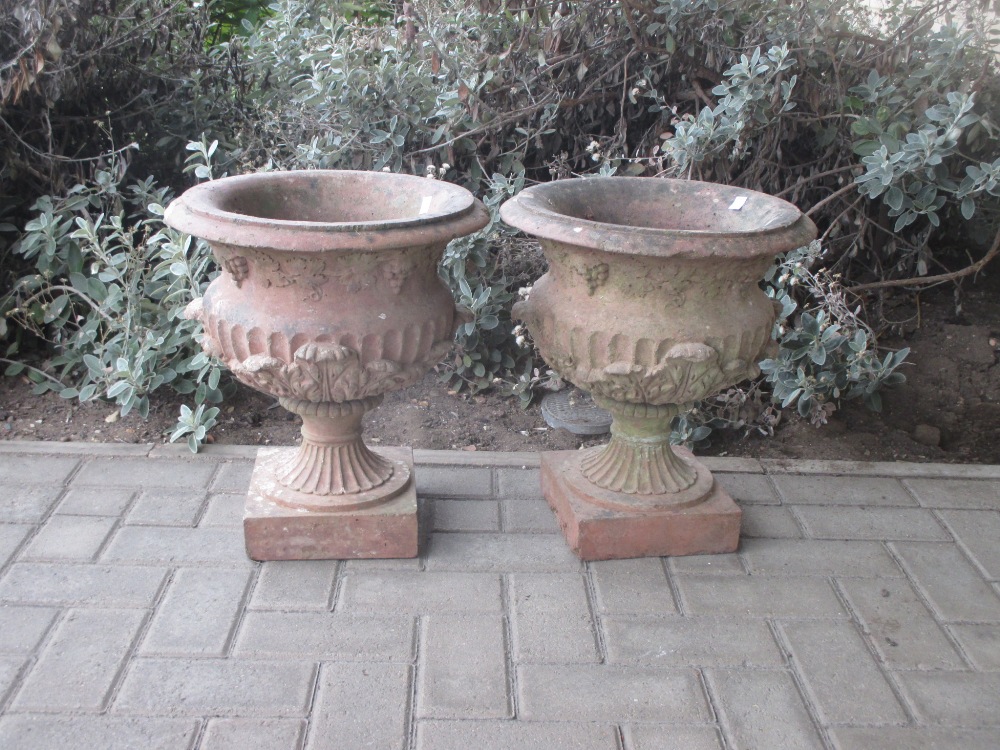 A pair of terracotta garden urns 44cm high 39cm wide (2)