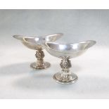 A pair of 20th century silver salts, each of deeply dished navette form and raised on a circular