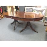 A Victorian mahogany twin pedestal dining table with two additional leaves