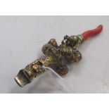 A gilt metal rattle with coral teething bar and whistle
